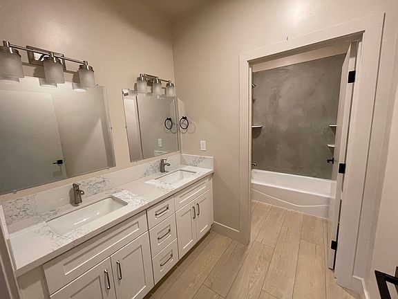 Brand new bathroom #2 features modern and easy-to-clean stucco shower enclosure. Double sinks make it easier for multiple people to share the bathroom. Separate water closet completes the full bath, with additional storage built-in over the toilet.