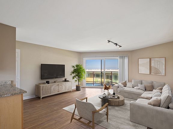 Spacious living roome with wood flooring throughout