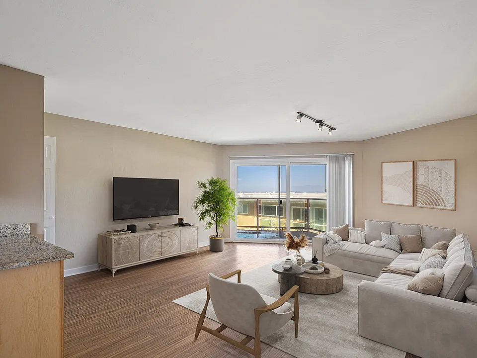 Spacious living roome with wood flooring throughout