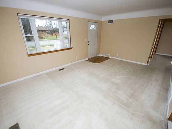 Another view of the living room.  The newer vinyl windows allow natural light to fill the space.  The hallway visible on the right side of this photograph leads to all three bedrooms and the updated bath.