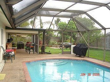 standard screened pool with dog door access and fully fenced yard
