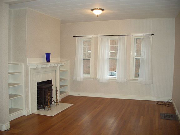 Open living & dining area with hardwood & gas insert