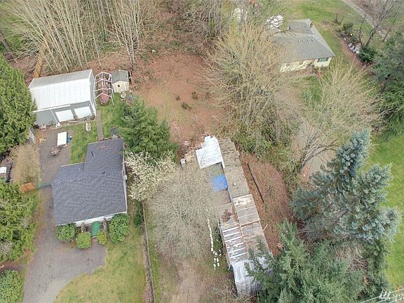 Aerial shot shows west end of property.  East end, behind trailer and neighbors home is treed.