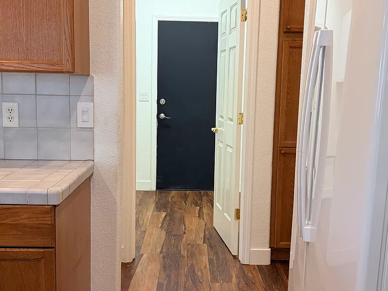 Kitchen looking towards laundry and door to garage