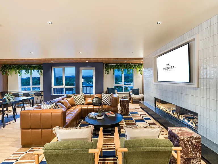 The inviting resident lounge at Modera Beaverton offers cozy seating, scenic views, and modern design for relaxed gatherings.