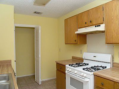 Galley kitchen open to living room.