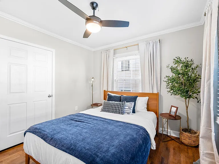 This room features a stylish dresser and a small closet, providing convenient storage solutions without compromising on aesthetics. Close the blackout curtains before jumping into the queen-sized bed for ultimate relaxation.