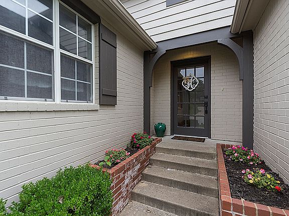 Welcoming Entrance with raised landscape beds and 15 Lite Entry door.
