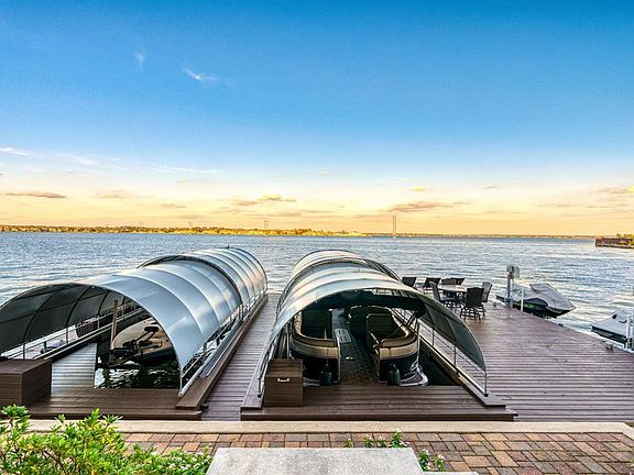 Incredible boat dock with two boat slips and two jet ski lifts - plus expansive deck area for entertaining!