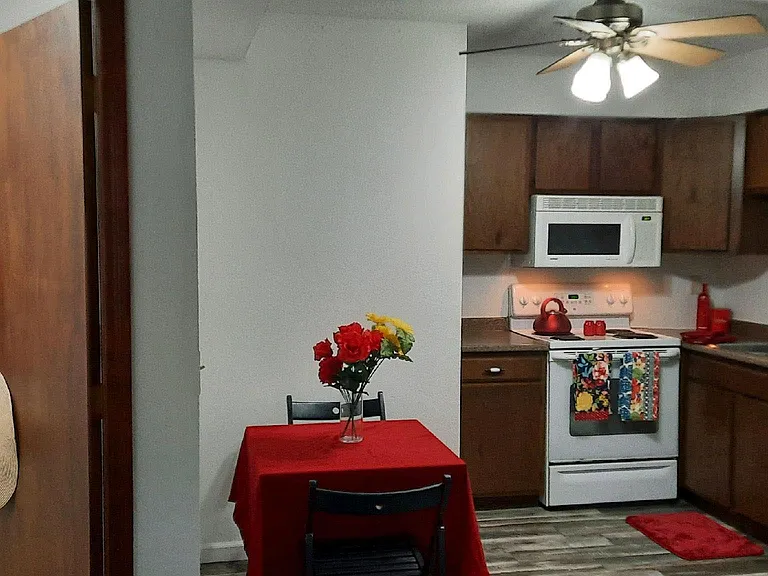 ....an over-stove microwave, stove with self-cleaning oven, dish washer and refrigerator complete this versatile, efficient kitchen area...