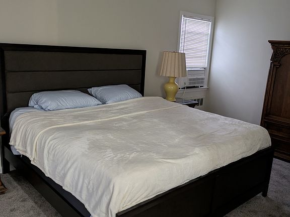 king size hybrid bed in master bedroom with fan and 10000 btu quiet window ac