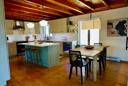 Kitchen with island, quartz countertops, vented range hood, 2 zone wine cooler