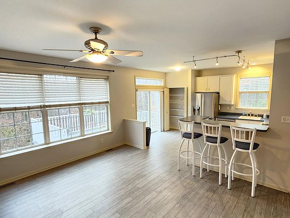 Open kitchen with new appliances and view of woods