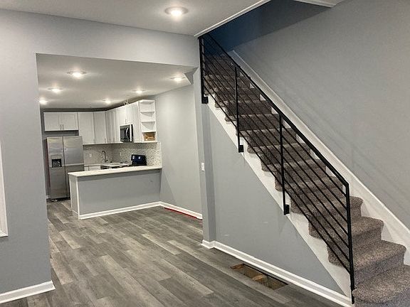 Stairs to second floor, dining room & kitchen