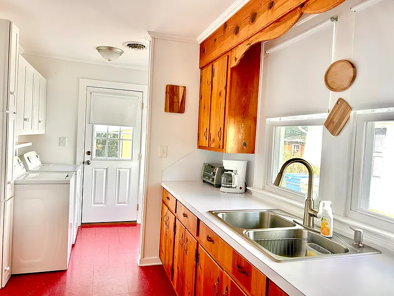 Washer and dryer conveniently located off of kitchen and back door entrance to yard and outdoor seating