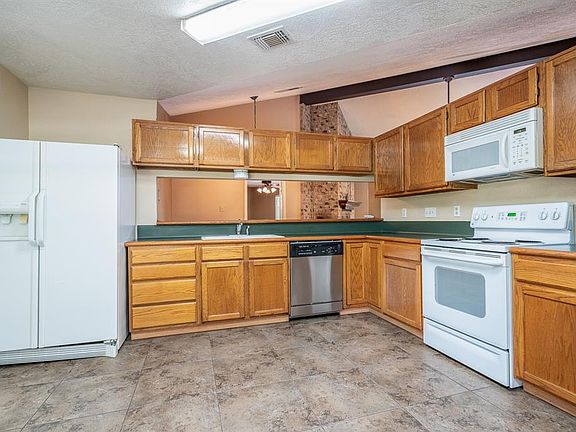 Kitchen has lots of cabinet space and pass through to dining area.