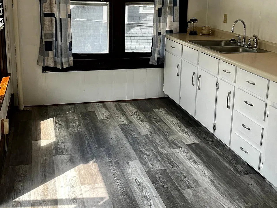 Kitchen, new floor, freshly painted with large windows.