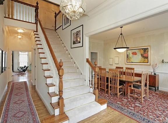 Spacious entry foyer with wood floors, 10' ceiling height and ce