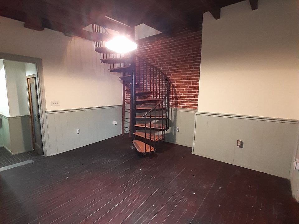 Living room and spiral staircase to second floor