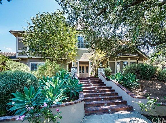 Elegant plantings flank the stairway to the home's front entry.