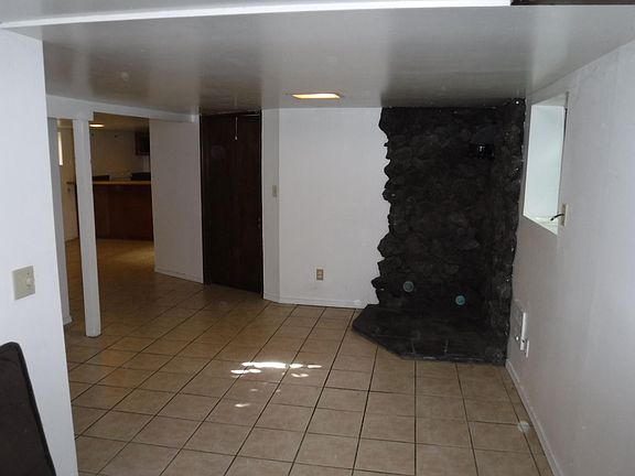 Living room, view toward kitchen and door to garage