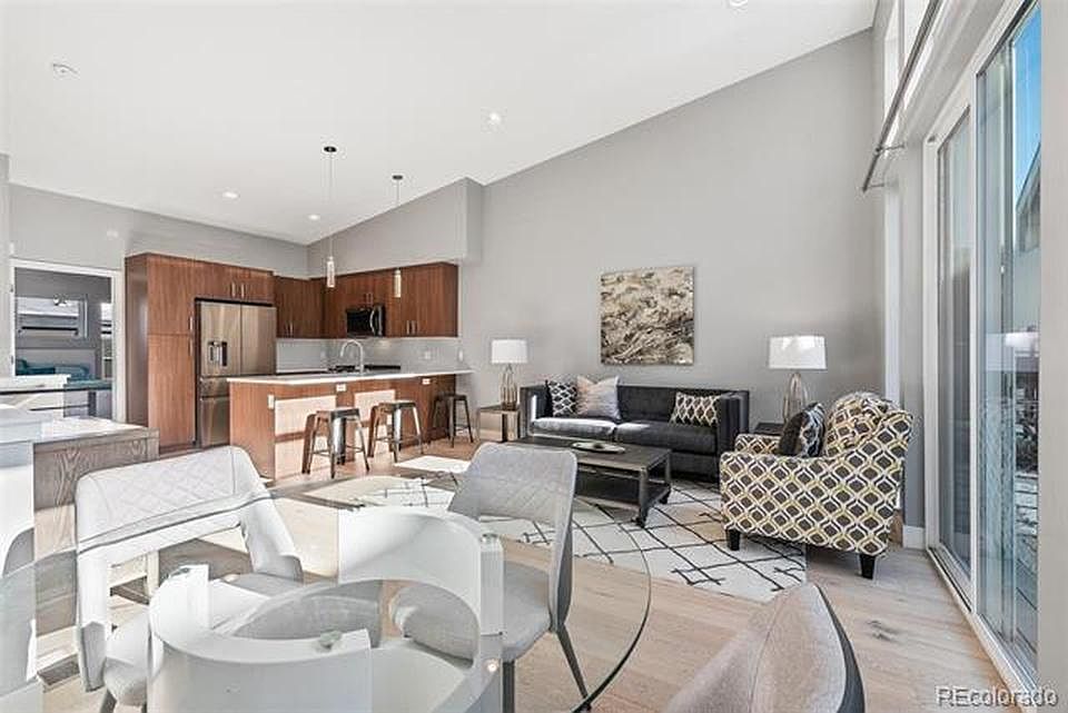 Open living/dining/kitchen with large windows
