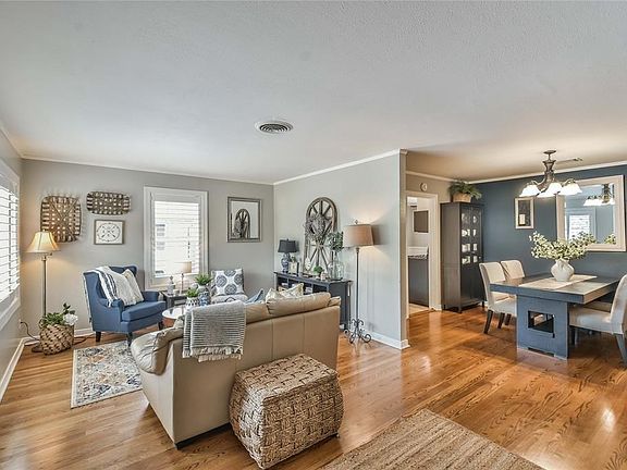 Lovely formal living area that opens to dining room. Original Hardwood floors and an abundance of natural light.