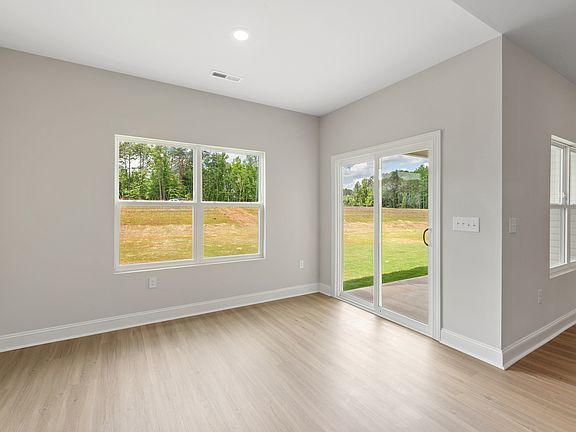 The dining room has glass sliding doors that lead o the covered back patio