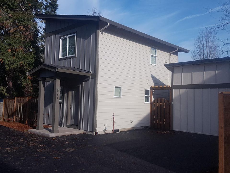 Front of Home with 10x10 Locking Storage Shed Behind Gate