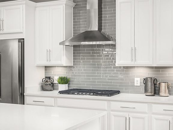 Gourmet Kitchen with Quartz Countertops, Hardwood Flooring and Stainless Steel Appliances