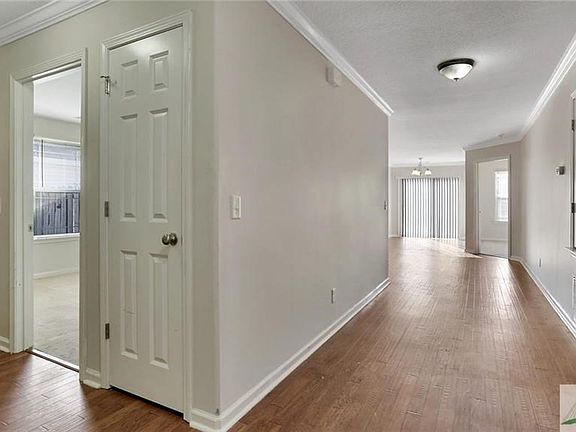 Bedroom 3 to the left, bedroom 2 to the right, master at the end. Wide hallway entrance to the living room.