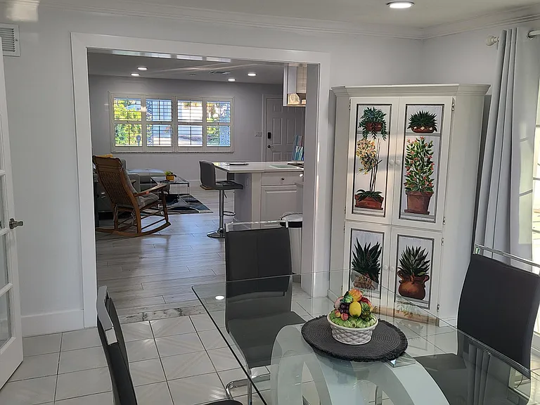 This is the dining area looking east into the living room and kitchen