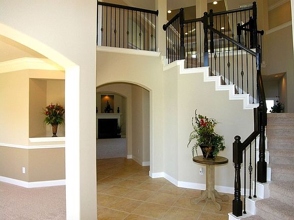 Curve staircase, extended tile flooring.