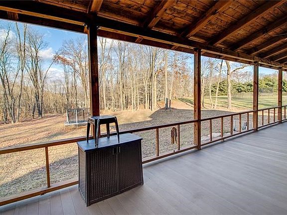 Perfect for entertaining, this 53'x12' aluminum waterproof deck has three ceiling fans, wire rails and an Amish built roof.