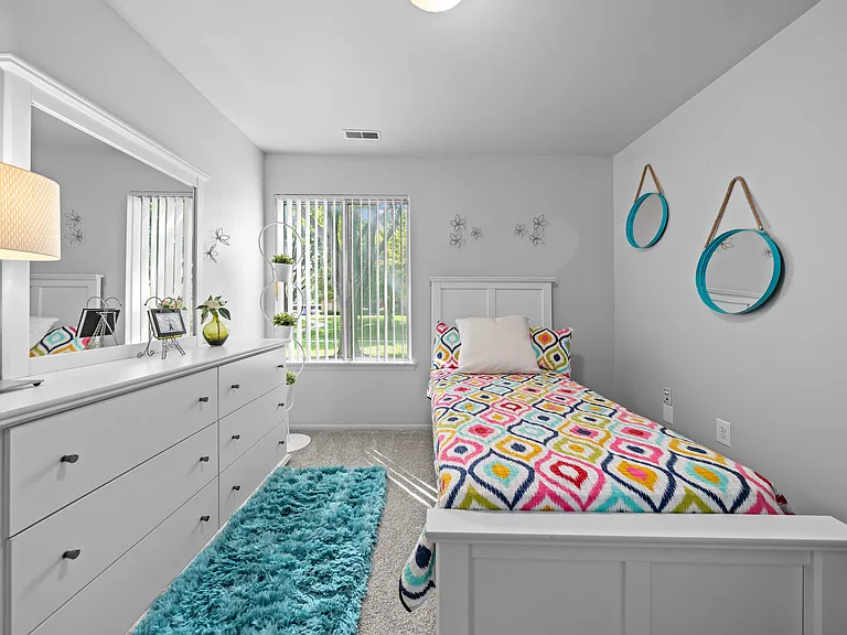 Bedroom with natural lighting at Westwood Village Apartments in Westland, MI