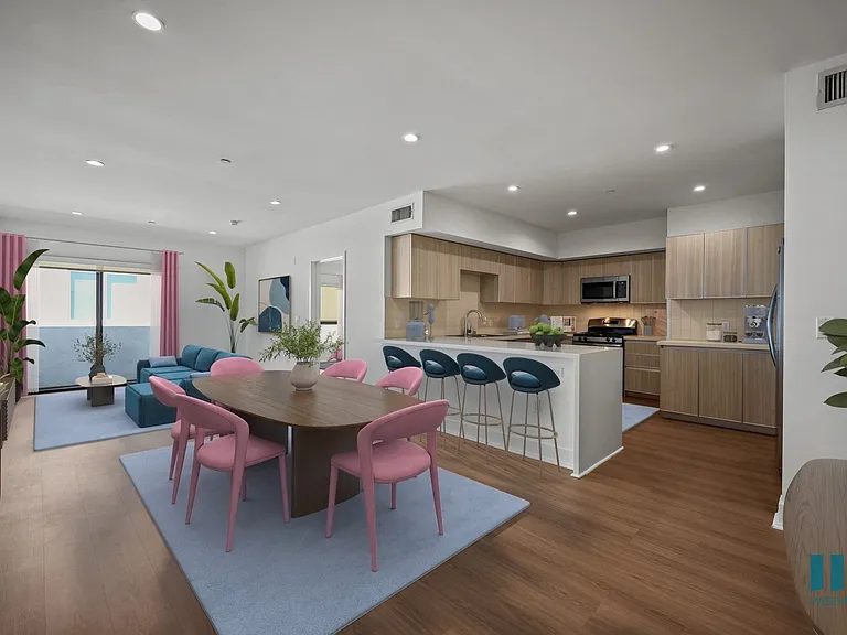 Open-Concept Kitchen with Countertop Bar, Dining, and Living Room with Patio