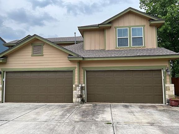 Garage and driveway with direct access to the street. Front door around the corner with a side entry.