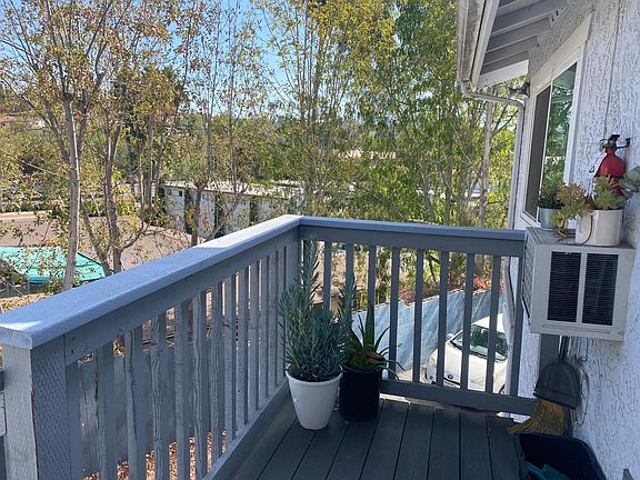 Outside your front door you have a little patio on the right to place plants or 2 chairs or ? To look at the view of the tops of trees.