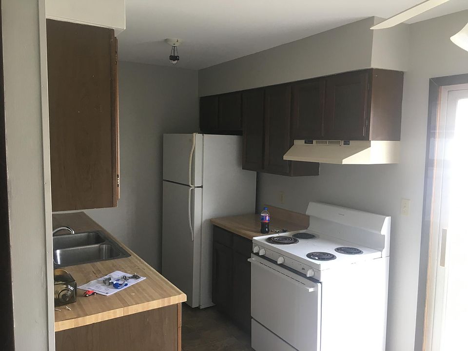 Galley style kitchen, dishwasher, electric stove and refrigerator included.