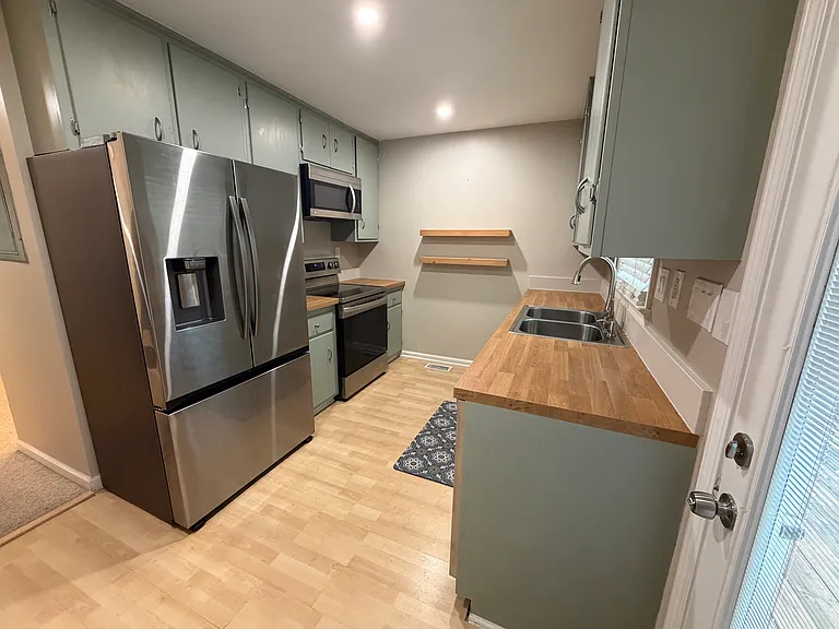 Kitchen with large fridge/freezer, oven, dishwasher, microwave and plenty of natural light