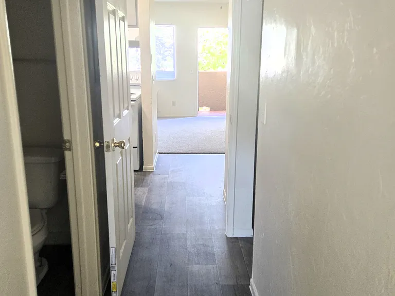 The hallway from the bedroom with a split bathroom off the hallway