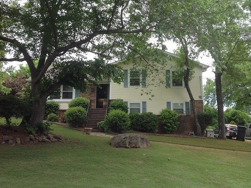 Front view of home
						:
						great shade trees in front. 
Weeds are not allowed in this yard