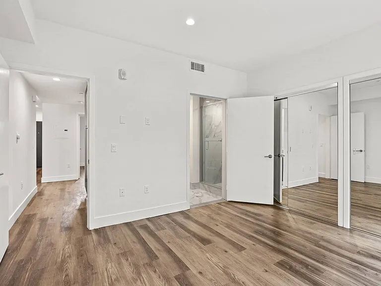 Bedroom with Bathroom and Double Mirrored Closets