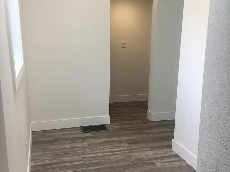 Large hallway leading from common room to bedrooms and laundry room. Can be used as an office space - plenty of room for a desk , armoir or large dresser.