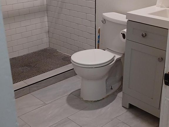 renovated bathroom with penny tile flooring