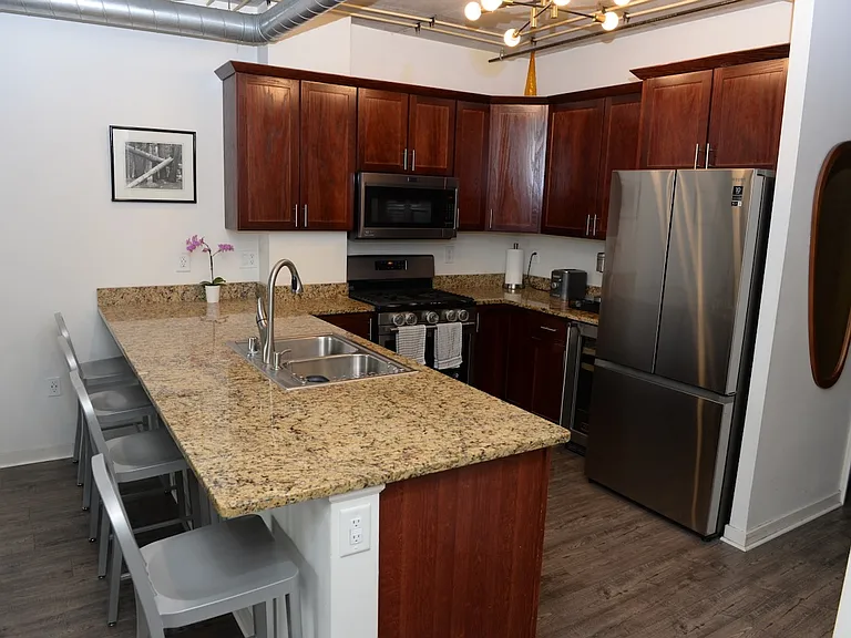 Kitchen with brand new wine fridge and adjacent brand new washer/dryer.