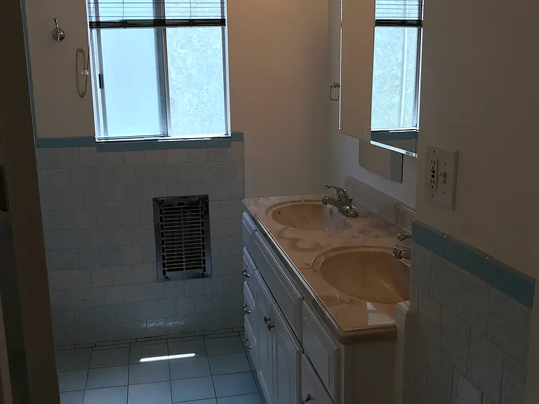 Hallway bath has double vanity, electric heat, tub and shower, and new toilet.