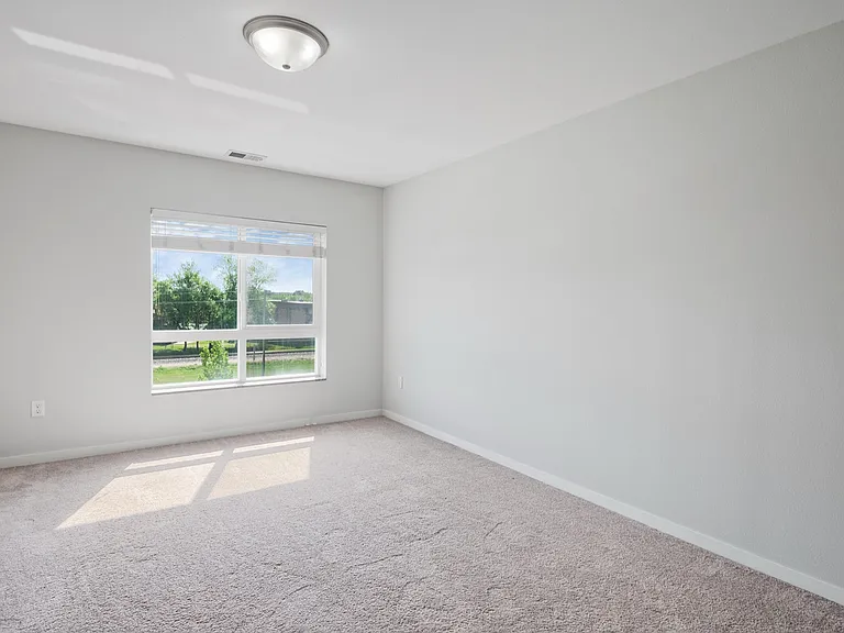 Bright and spacious empty room with large window offering natural light and scenic views, ideal for personalization and comfort. Bright and spacious empty room with large window offering natural light and scenic views, ideal for personalization and comfor