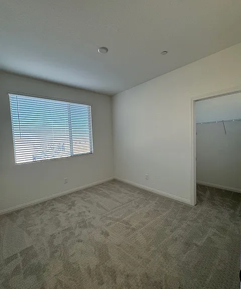 Bedroom 3 with walk in closet & mountain views - modern ceiling fan w/light installed