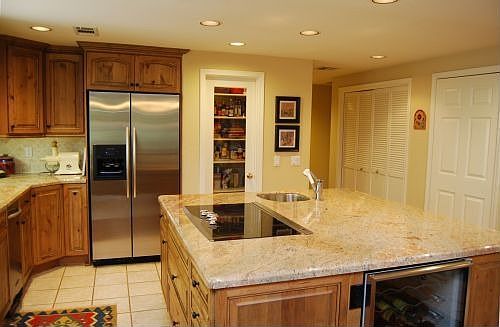 Updated kitchen with slab granite, upgraded appliances, pantry and wine cooler